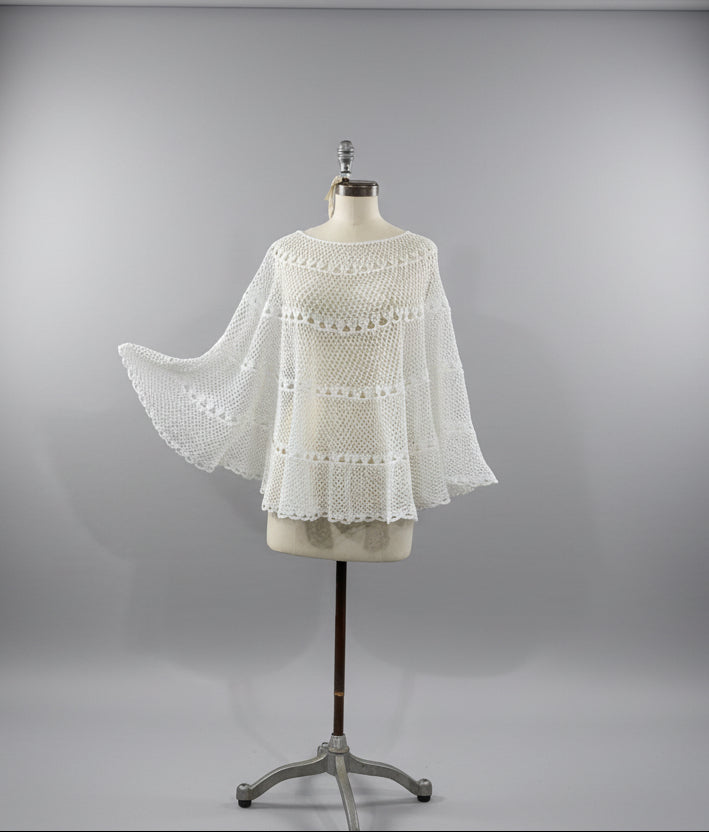 White lace garment on a mannequin against a neutral background