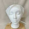 White headscarf on a mannequin head with a beige background